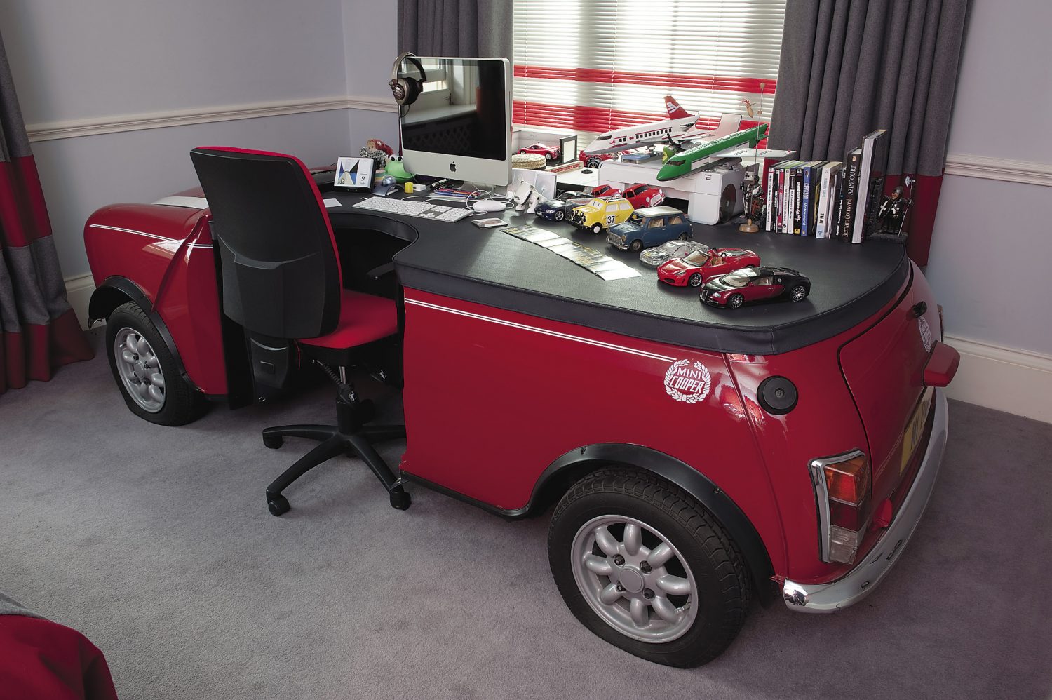 Theodora’s teenage son’s bedroom is a homage to The Italian Job. A full size Mini Cooper has been converted into a desk and the curtains feature the Mini logo as the pelmet motif