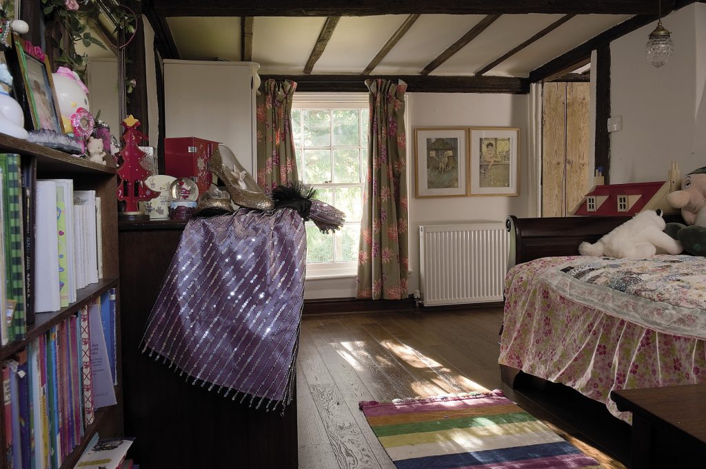 Louise’s daughter’s room features a handsome mahogany sleigh bed covered with another patchwork quilt made by her grandmother