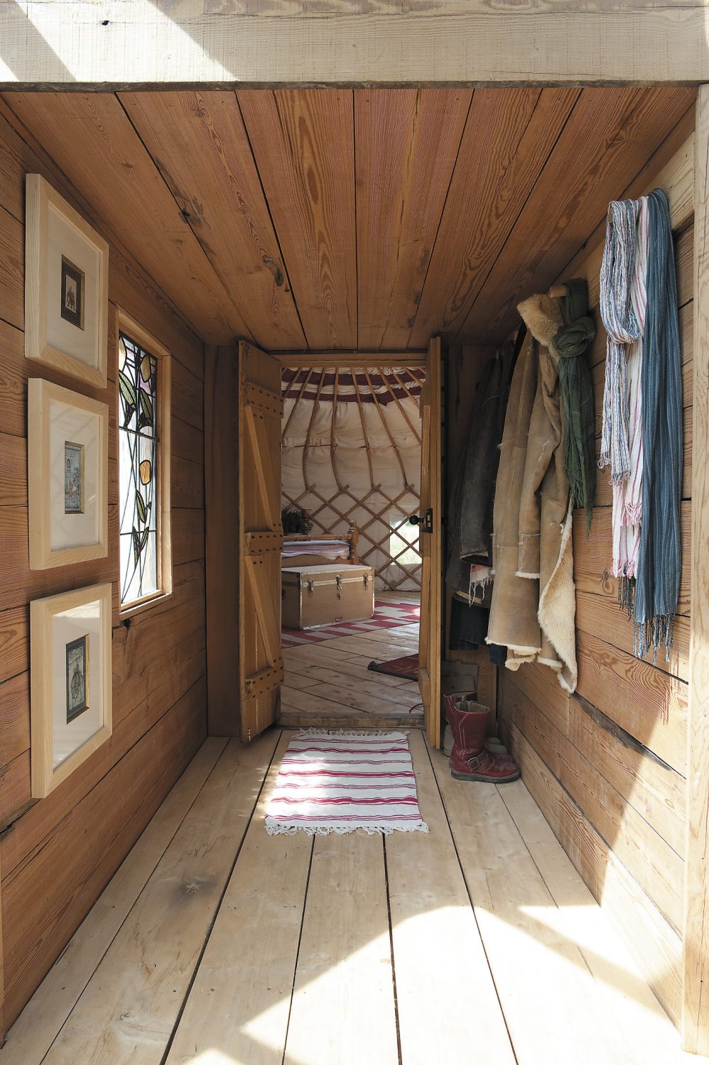 The small passage that connects the yurt to the conservatory is clad in reclaimed timber from Symonds Salvage in Bethersden