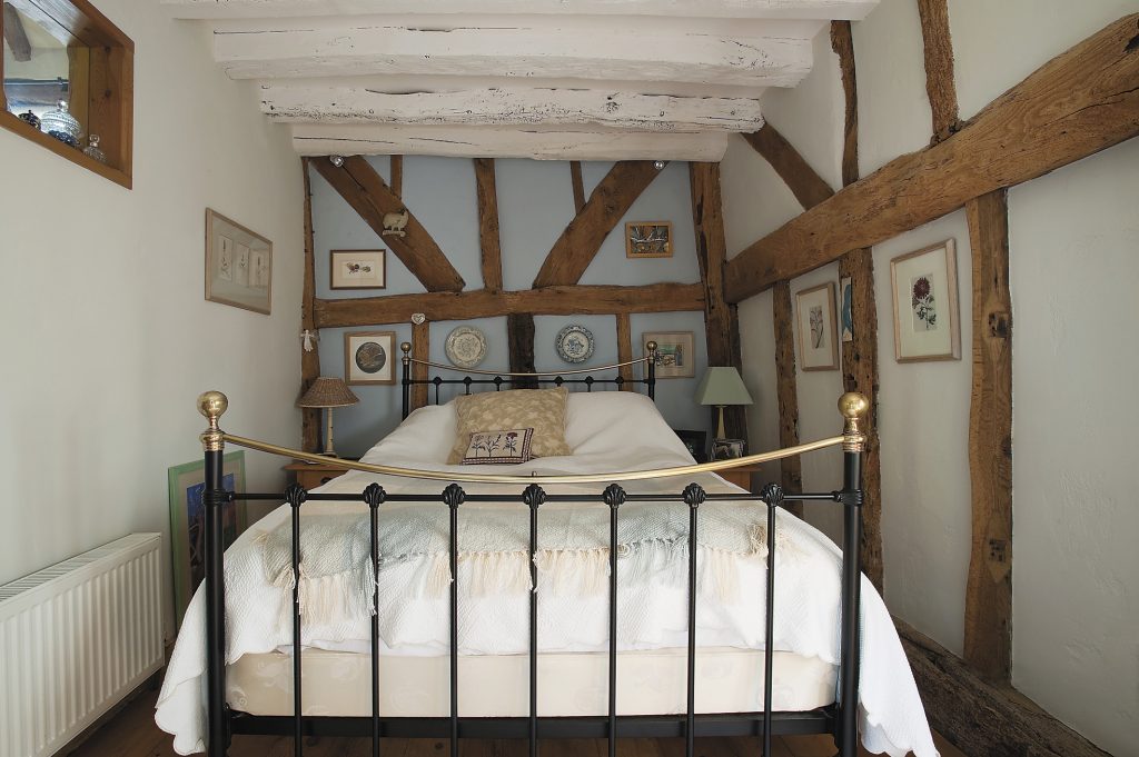 Sophie painted the beams in her bedroom white to add height and lightness bottom