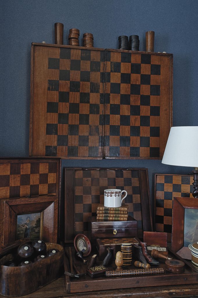 Dee’s collection of antique games boards and wooden decorative objects provides a talking point for guests