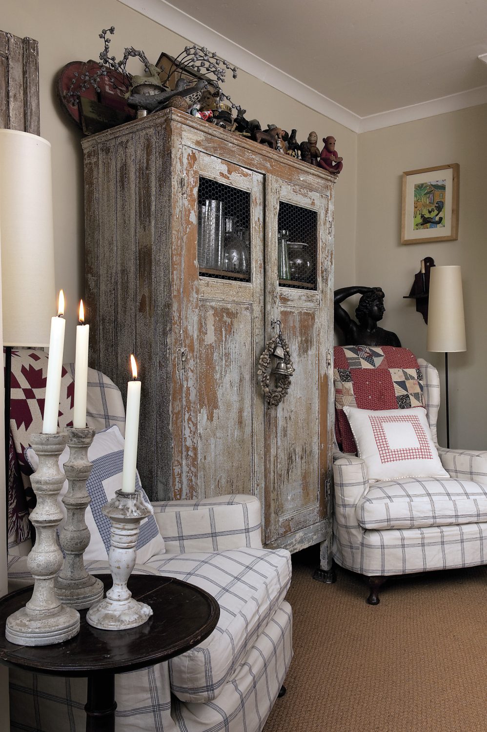 A large distressed grey French cupboard stands at the other end of the dining area, its long-lost original glass panels replaced very effectively by humble chicken wire