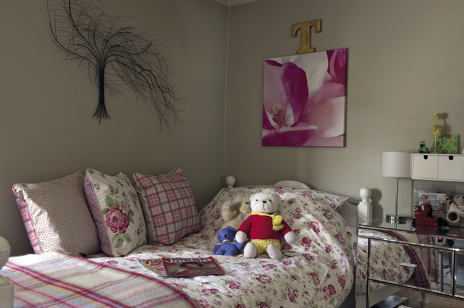 Even the pretty bedroom of a visiting child is complete with perfectly-placed finishing touches, including a vintage Jackie magazine
