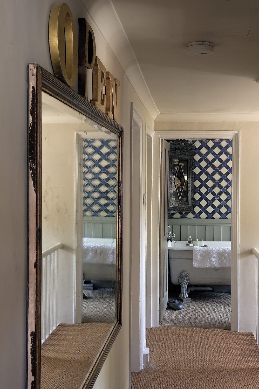 The view into the bathroom, past a huge gilt mirror