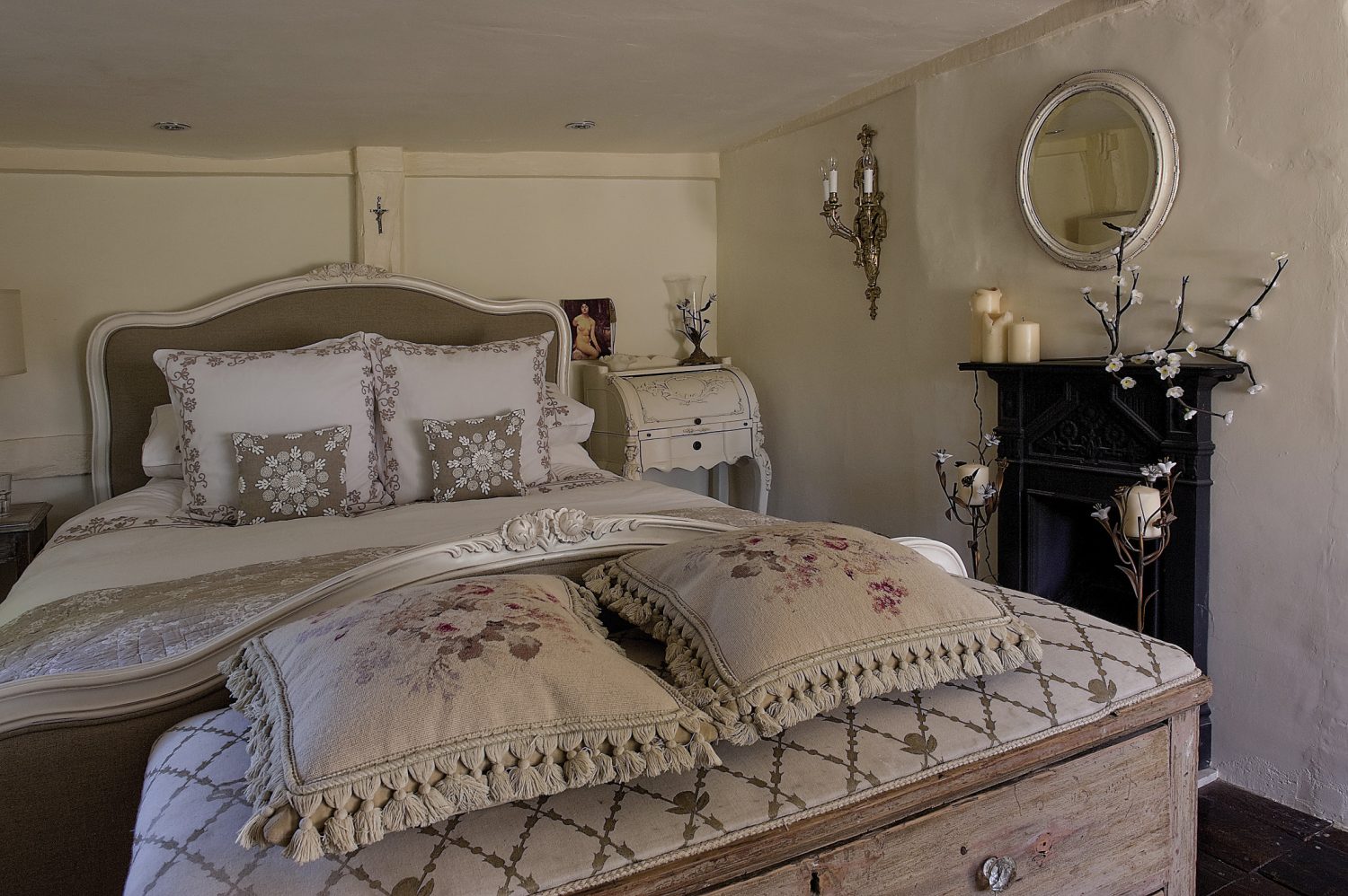 The main bedroom is both simply furnished and extravagantly embellished. The furniture is painted or limed and texture and pattern is added in the form of piqué bedcovers, silk throws and embroidered and appliquéd cushions
