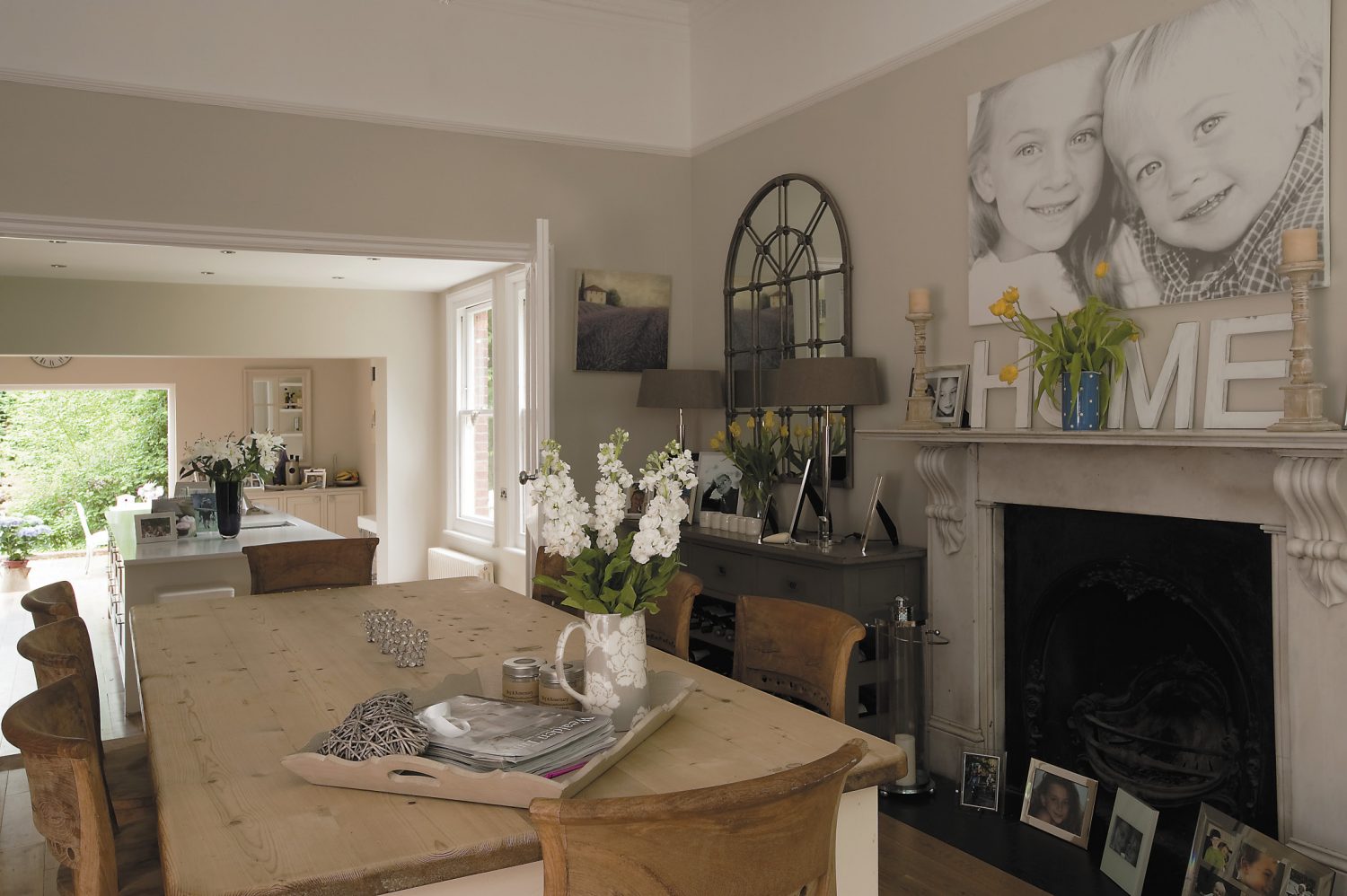 In the dining room, the first things to catch the eye are another beautiful white marble fireplace – virtually every room in the house still sports its original marble fireplace – an imposing glass-fronted armoire in French grey and two very effective Georgian mirrored windows.