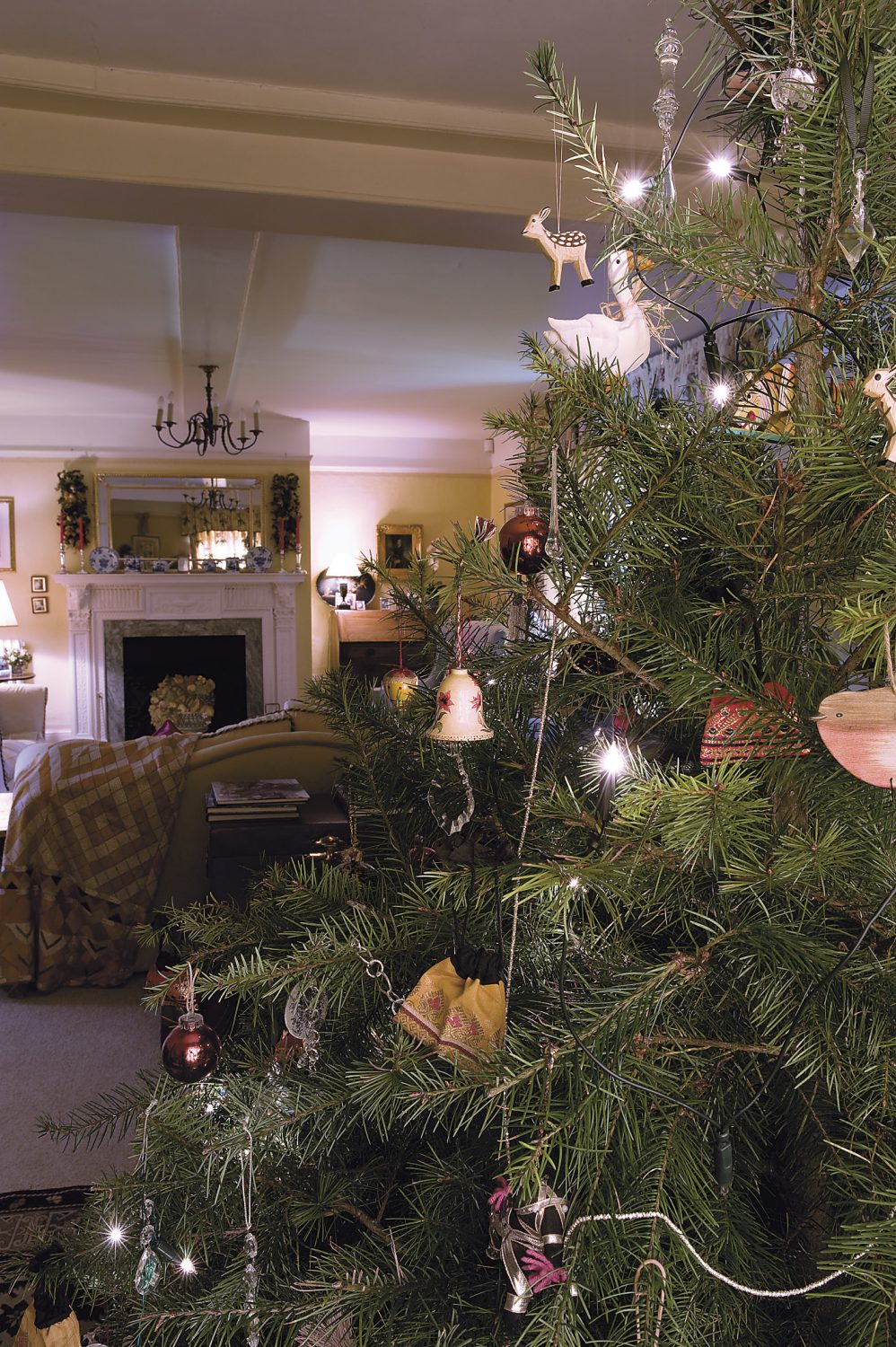 the Christmas tree in the drawing room has traditional decorations which have been collected by the family over the years