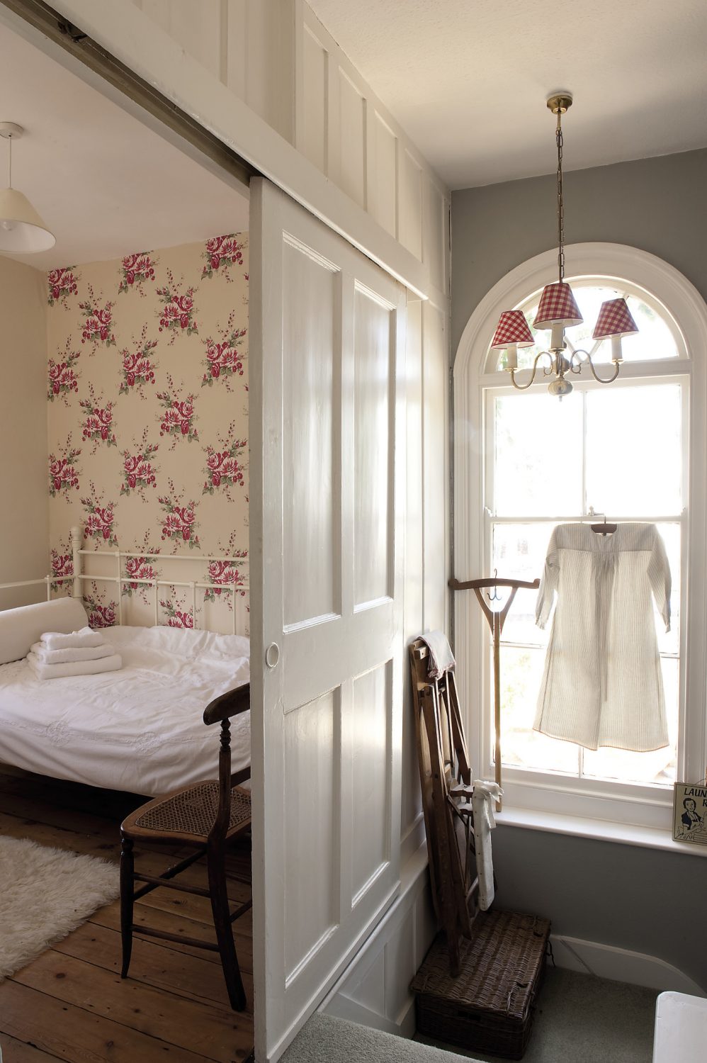 Just across the corridor, behind a sliding door and tucked away in the tower, is a small wood-panelled bedroom that’s very popular with visiting children. There is an iron daybed and the wall behind it is papered with jolly, striped red and white roses...