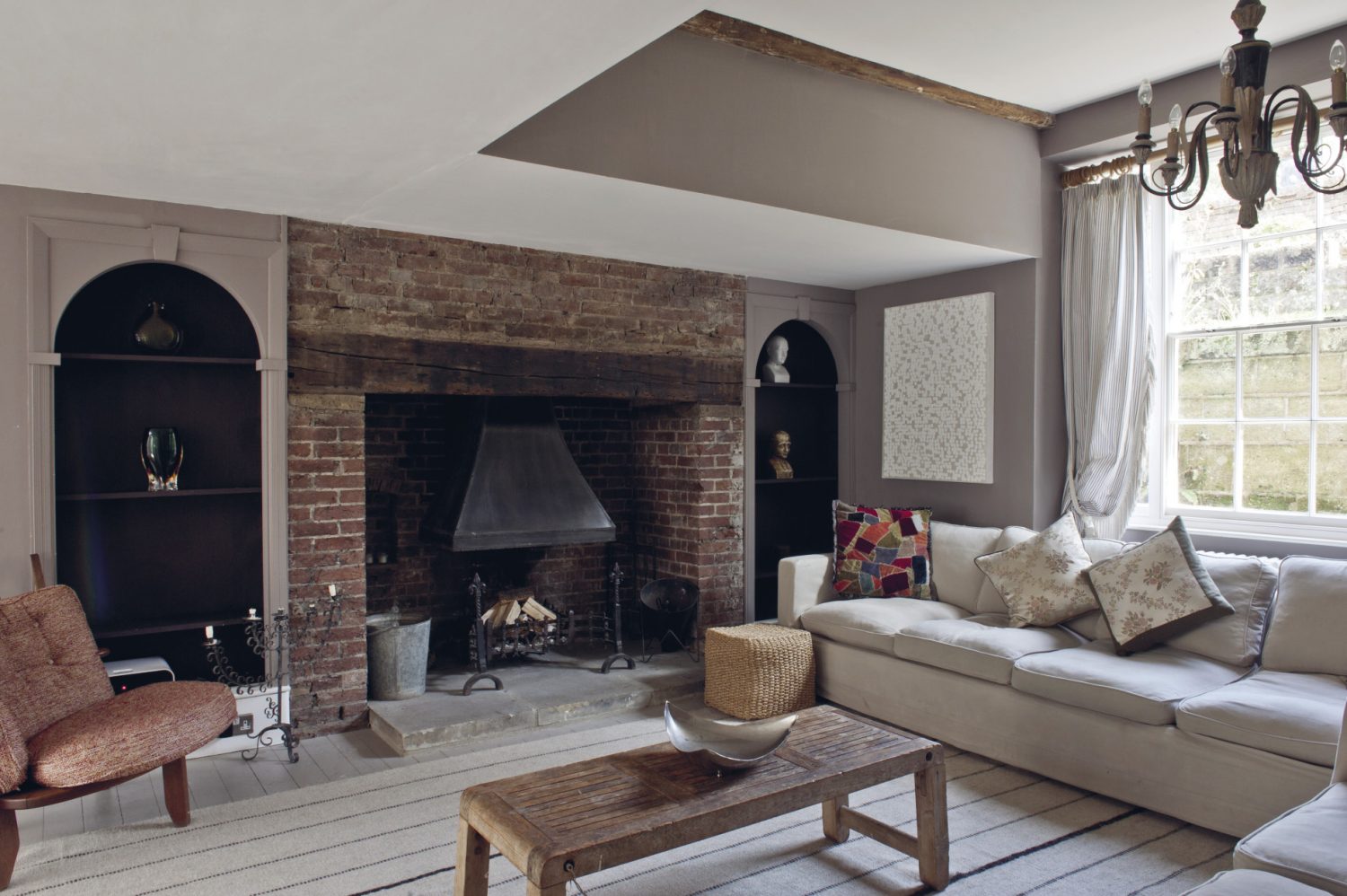 At the other end of the sitting room, two huge comfortable sofas are placed around an original inglenook where log fires burn in the winter months