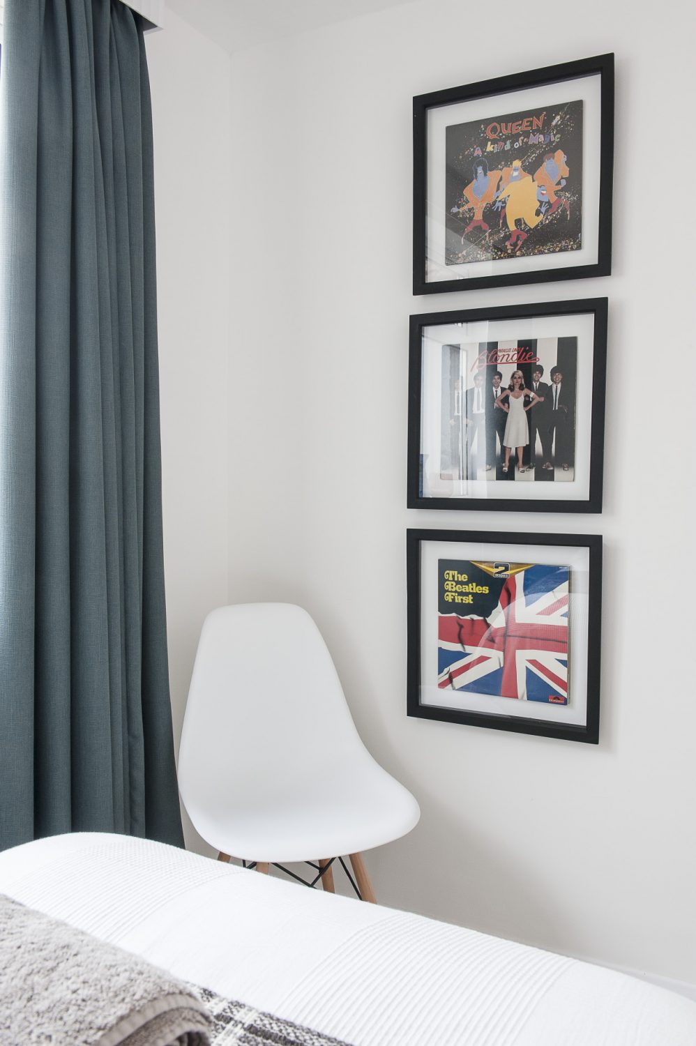 A trio of framed album covers are mounted onto one wall
