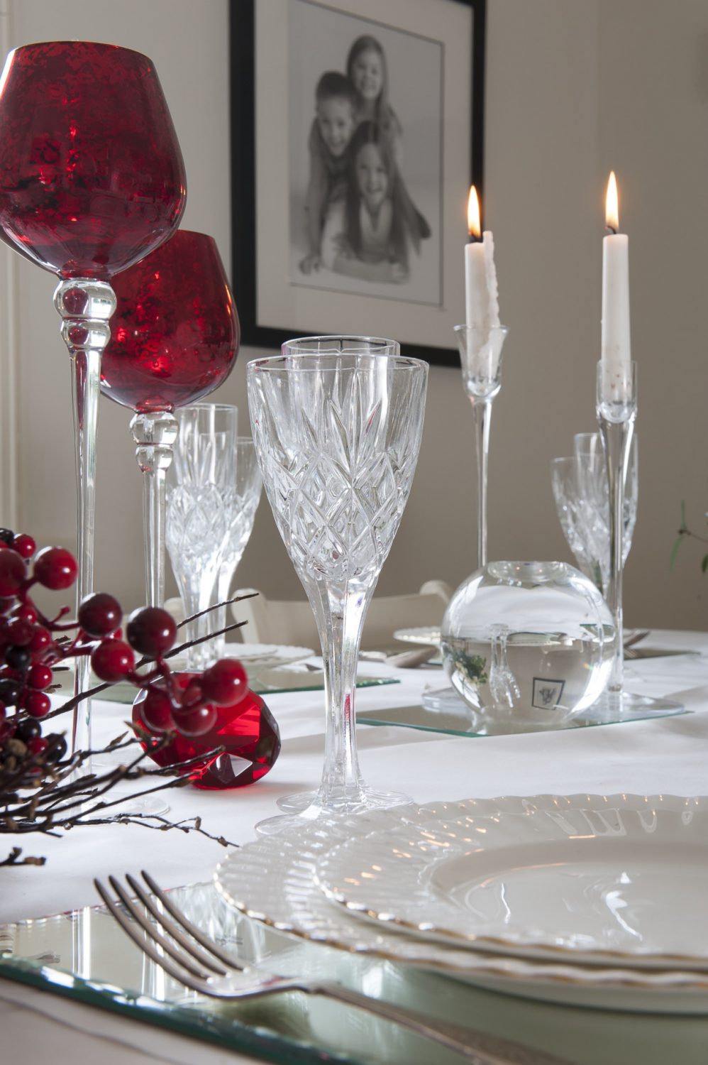 Steph and her friend Nicky have dressed the dining table with cut crystal glasses and cranberry glass goblets