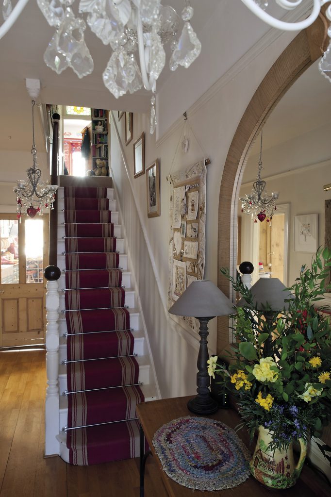 The stairs are covered with a smart red and cream Roger Oates’ runner