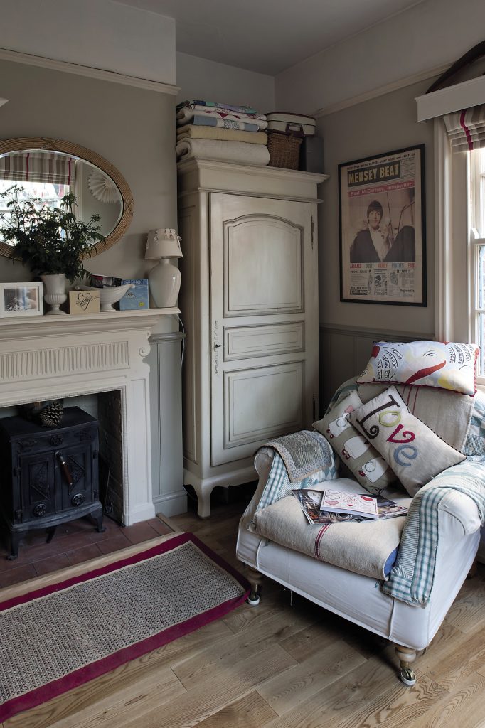 The study, painted in two shades of muted grey; the room has a serene feel, with armchairs covered with vintage linen and Mandy’s embroidered cushions and blankets.