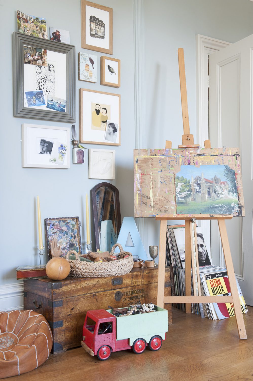 A riotous mix of oils, watercolours and pastel pictures and drawings line one wall