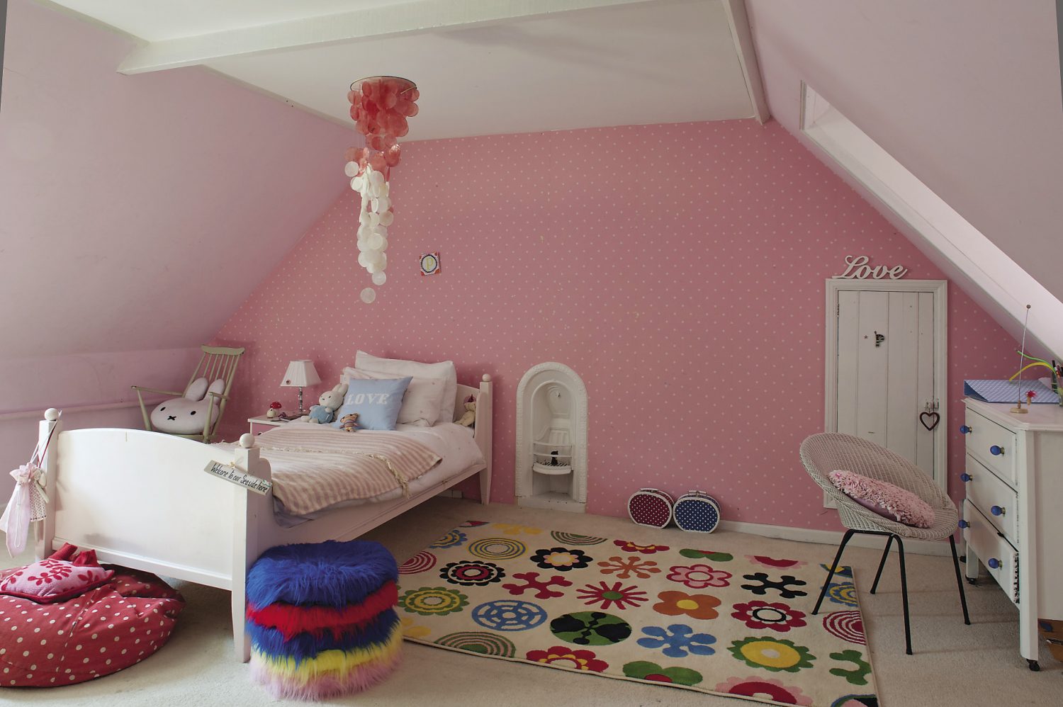 The older girls’ rooms are up another flight of stairs in the eaves of the house and decorated in cheerful shades of pink, blue or orange