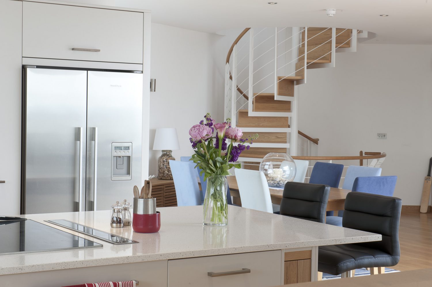 The kitchen, designed by Mounts Hill Woodcraft & Design, is sleekly efficient in appearance, with simple white cupboards and stainless steel appliances