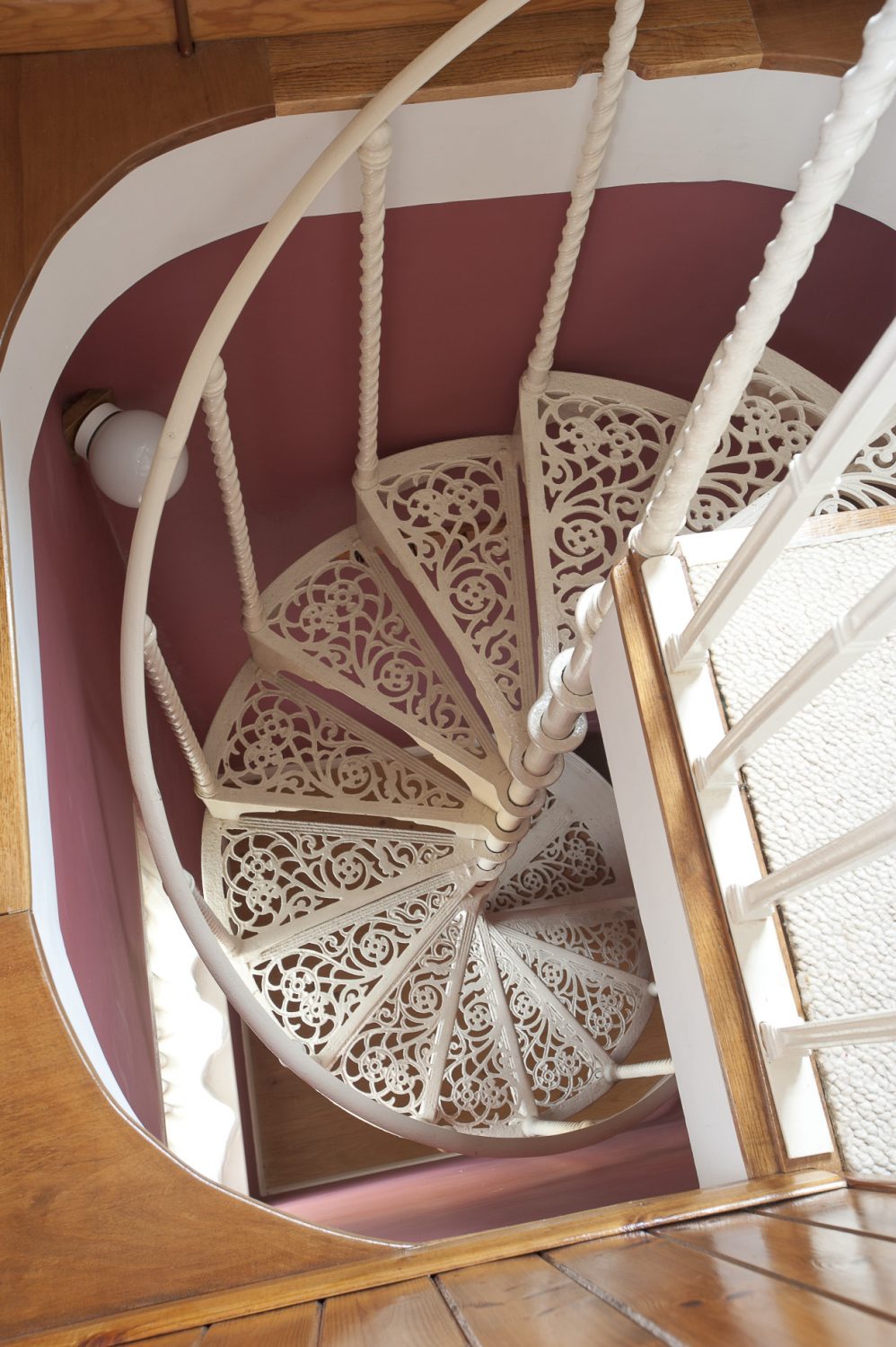The intricate wrought-iron spiral staircase
