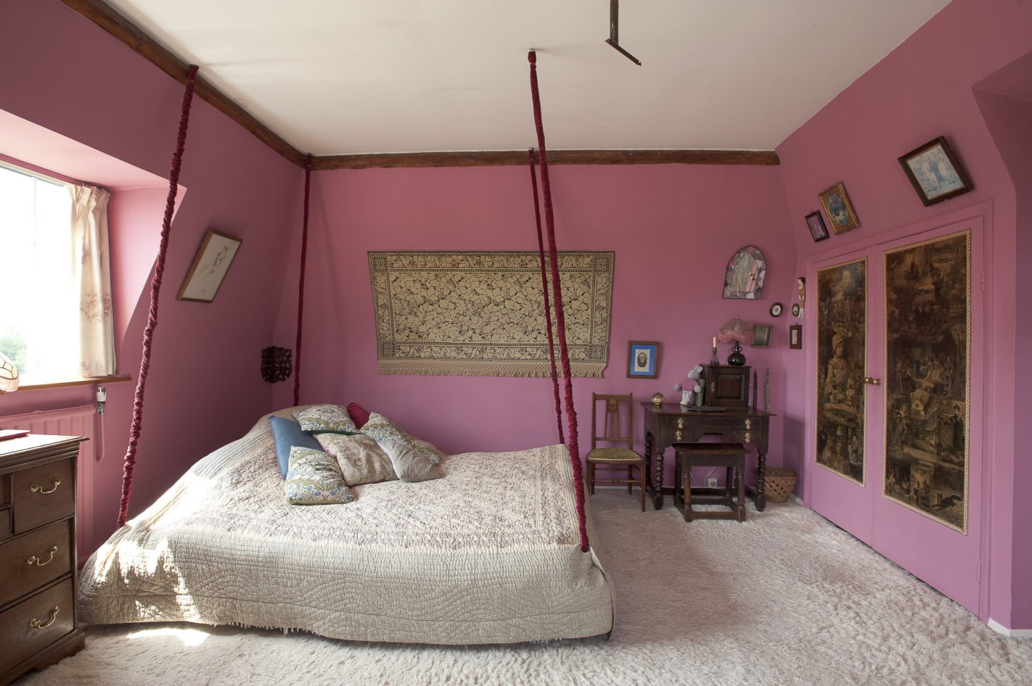 The master bedroom features a wonderful full-size double bed suspended from the ceiling