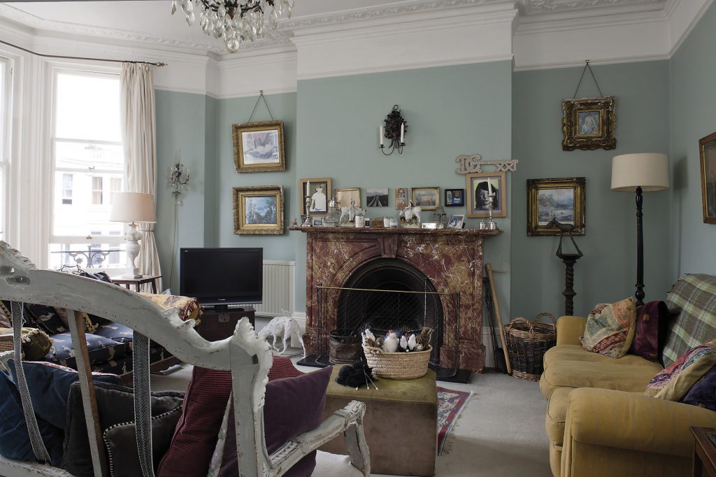 The drawing room is home to several sofas and chairs in the room, including a rather ornate French wooden one that has only been upholstered on its seat, leaving the wooden structure at the back completely open like vertebrae of a skeleton