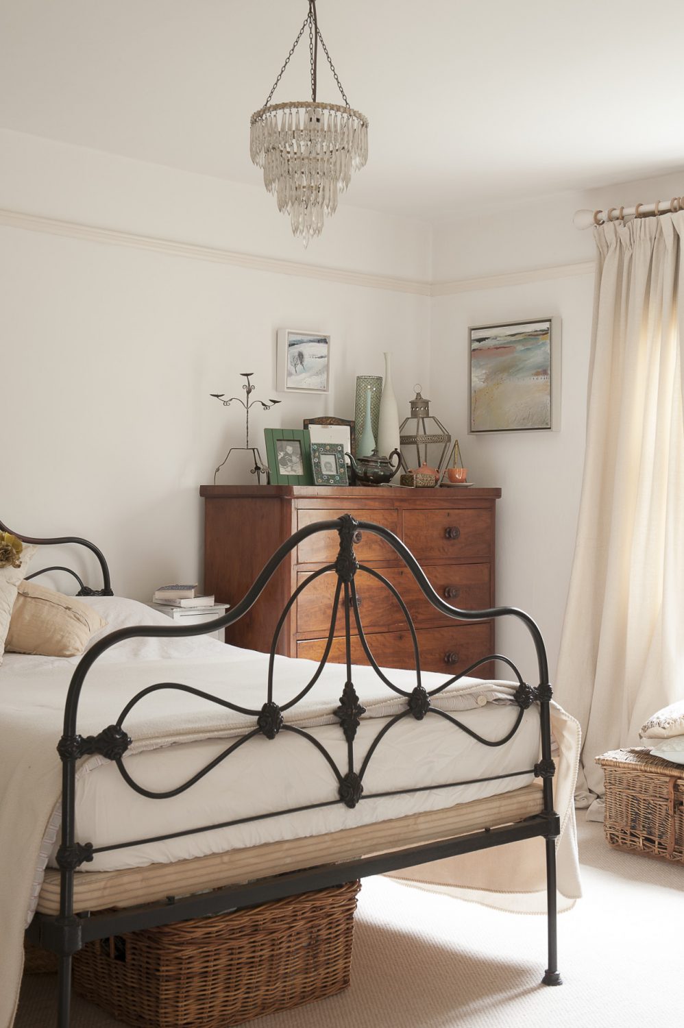 Upstairs the star of the show in the crisp, white master bedroom is a lovely period art nouveau wrought-iron bed