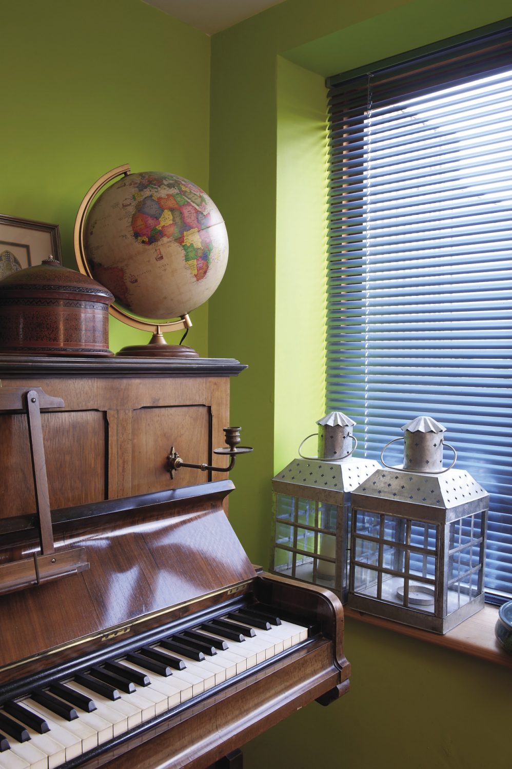 The study, home to Oliver’s floor-to-ceiling CD shelves, is painted a zingy lime green