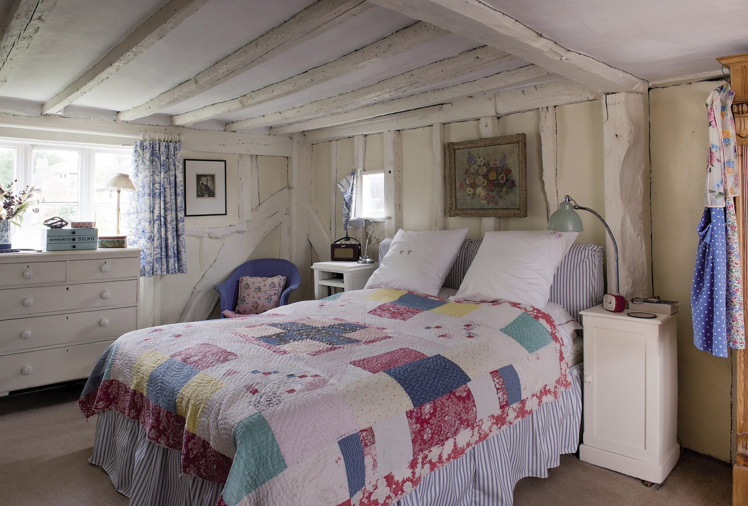 The bedrooms are full of vintage charm, with wonderful old patchwork quilts being used as wall hangings. On the beds are glorious quilts and, dotted among hats, scarves and bedroom bits and bobs are yet more neat piles of quaint old fabrics