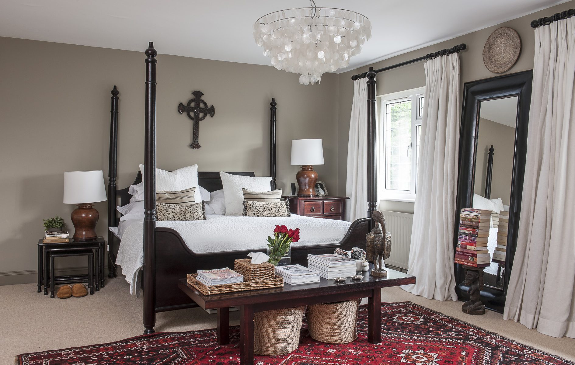 The simple, calm tones of Farrow & Ball Light Grey complement the Shiraz rug and four poster in the master bedroom