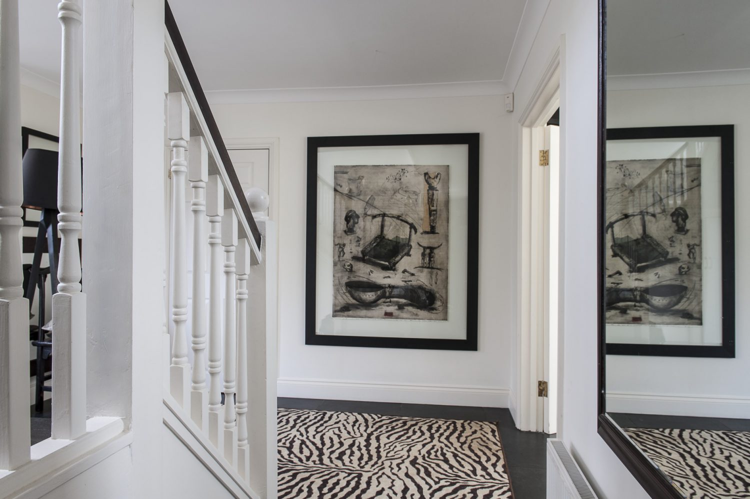 In the hallway sprawls a zebra print rug and on the wall a mixed media work by another RSA artist Debra Bell. In the children’s room sofas – one stone, the other black – lounge around a huge TV. On the wall opposite is a pair of antlers and a great wildlife print by one of the couple’s favourite artists, South African John Moore...