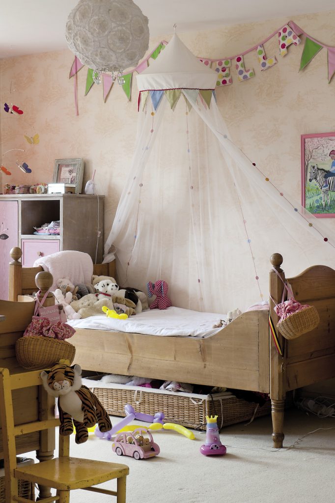 The girls’ bedroom shows more evidence of their grandmother’s affection, with framed pictures of both children set in magical surroundings painted for them by Terry. On a little yellow chair three hand-kitted bears huddle together.