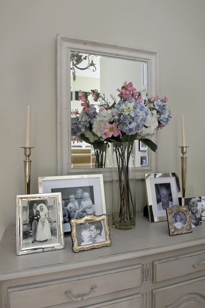 A handsome painted sideboard on the landing is covered with more silver-framed family photographs many of which feature Lucinda’s parents