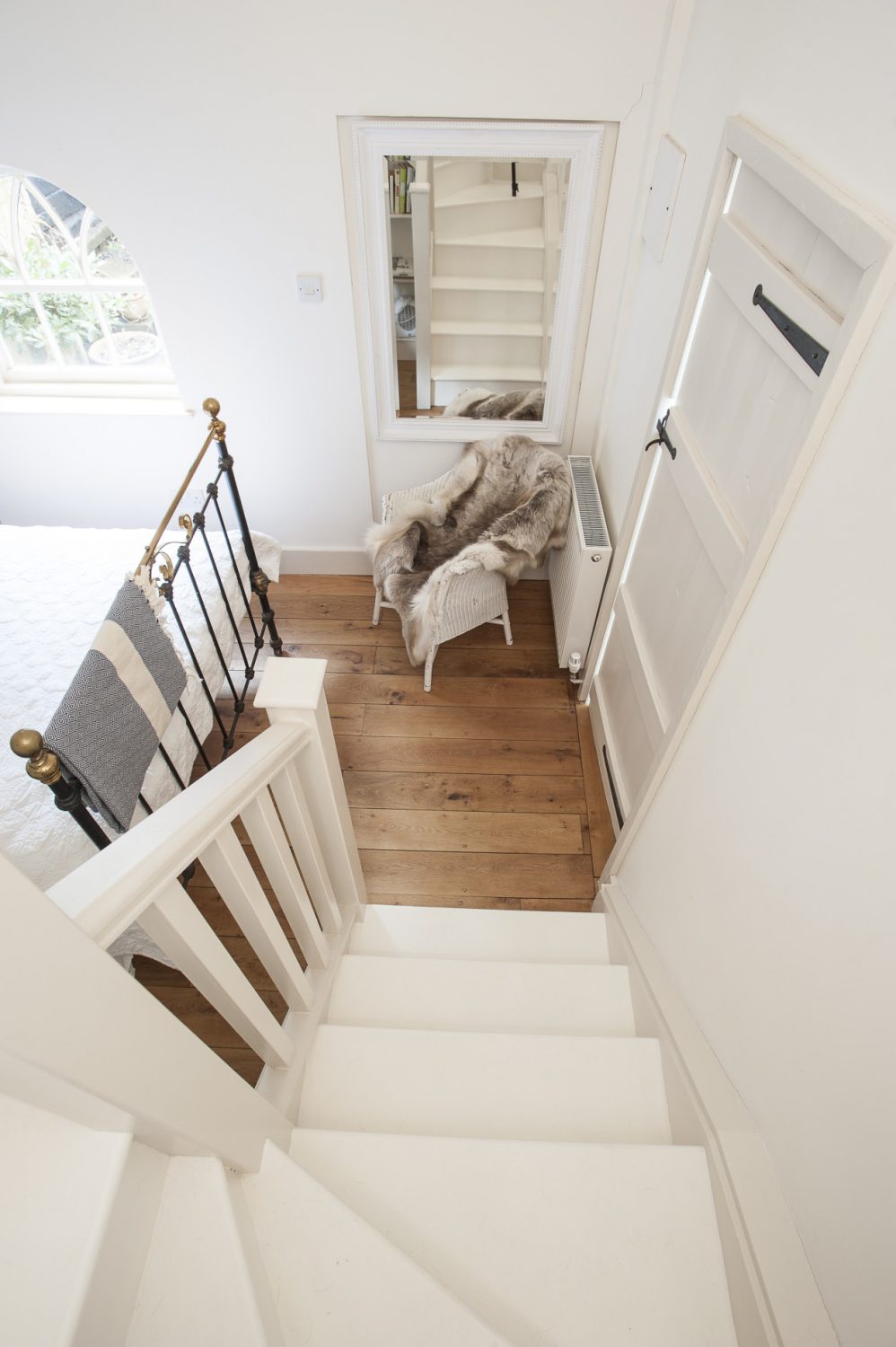 Up the stairs, off a little white galleried landing, is a wonderful en suite bathroom with roll-top bath