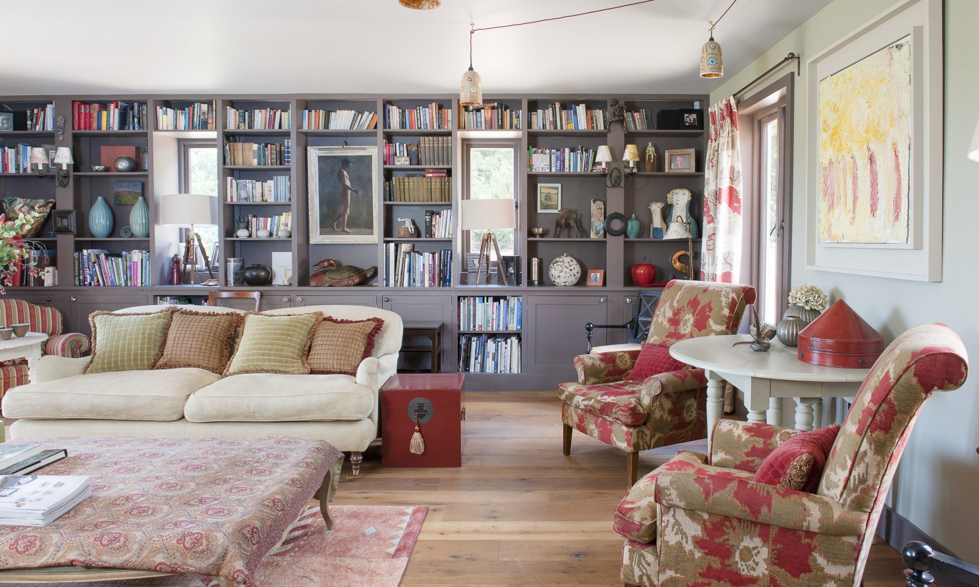 The double aspect drawing room runs the depth of the house and features bookshelves that span the length of one wall