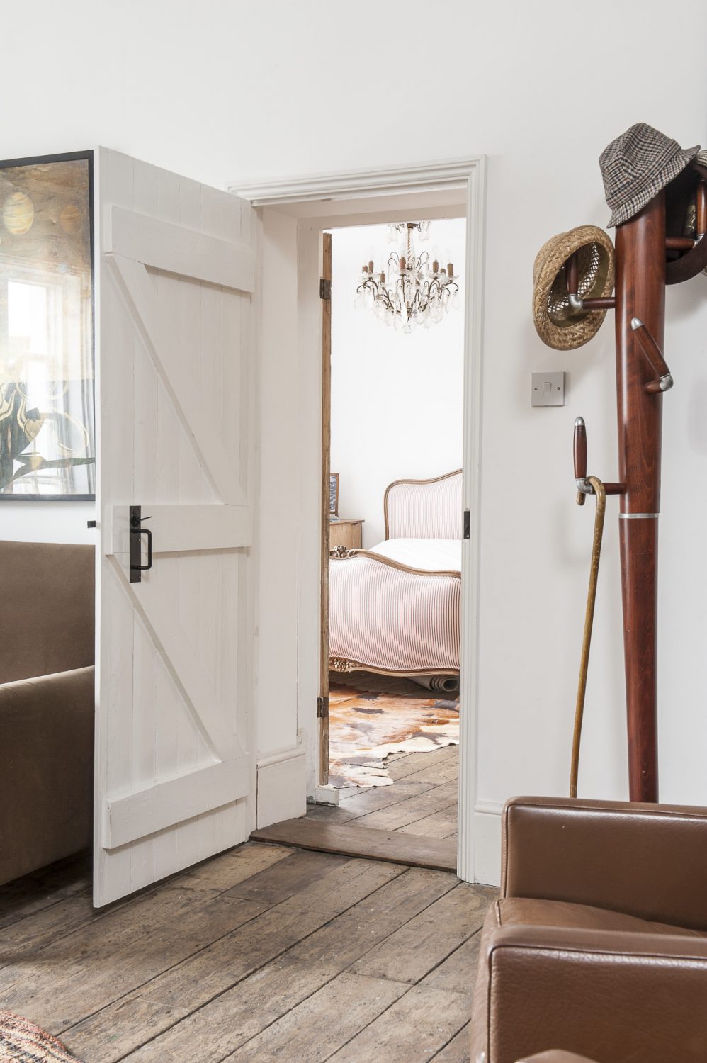 A door from the living room leads into the master bedroom. Rob has seamlessly combined an eclectic mix of contemporary and antique in each room