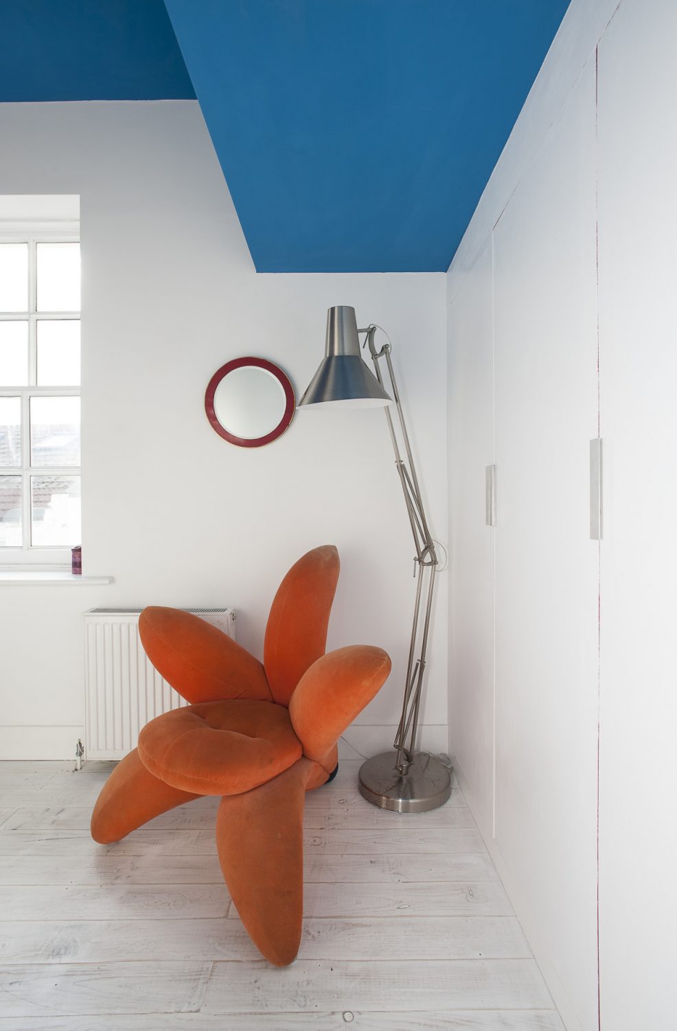 A second guest bedroom is home to a vibrant upholstered lily chair by Japanese designer Masanori Umeda