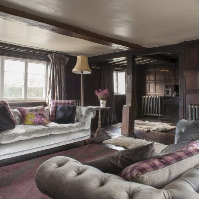 In the formal drawing room beautiful dark oak panelling, originally from a monastery and dating from the mid-1700s, covers the walls
