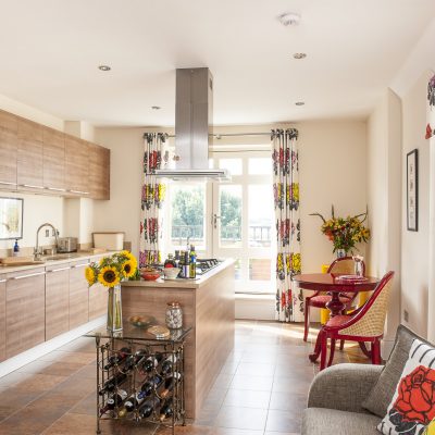 The state-of-the-art kitchen has been well thought out. It’s light and spacious, boasting two sets of French doors, one leading onto a balcony, the other onto a small terrace, both with a wonderful Wealden view