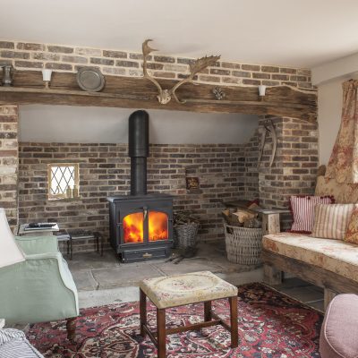 In order not to waste space under the sloping ceilings at the end of the garage, Caroline incorporated a sizeable inglenook that runs the full width of the room