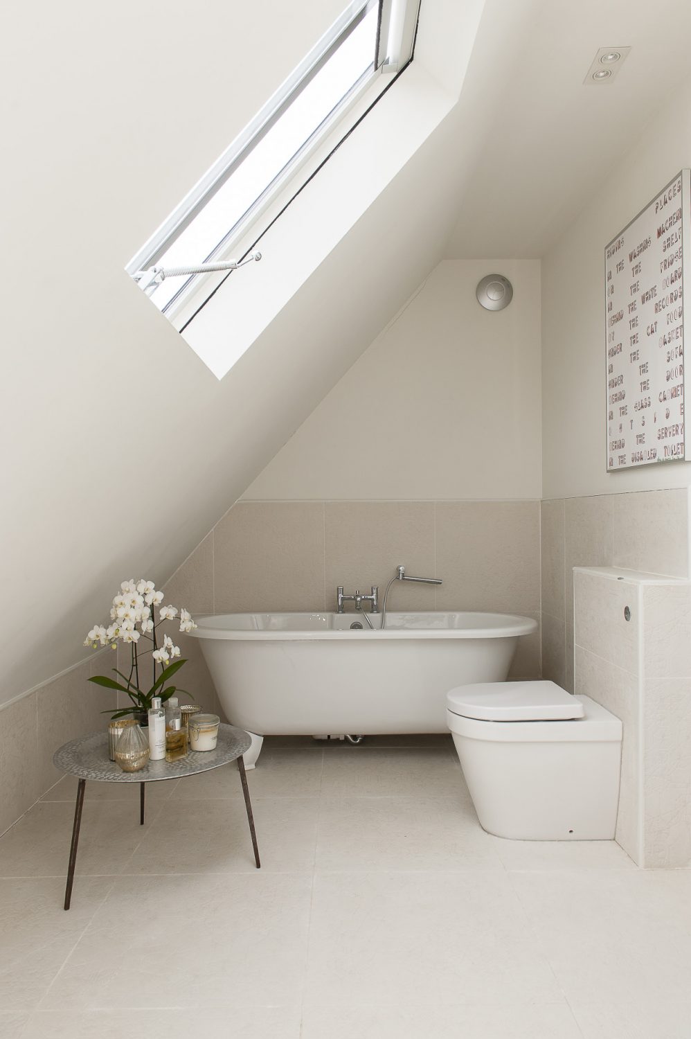 A family bathroom neatly slots into a space under the sloping roof upstairs