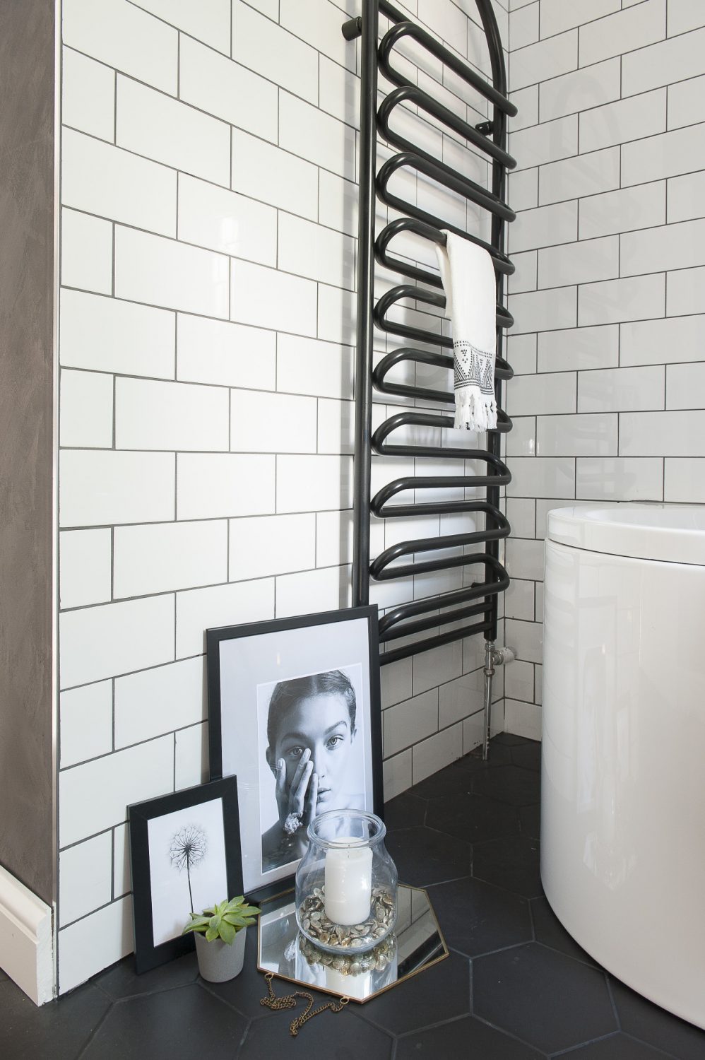 Liking its shape, Lucinda painted the radiator in the main bathroom black and updated the basin unit with sample pots of Farrow & Ball