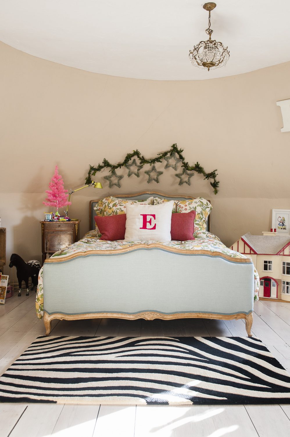 “I love beautiful beds,” says Kali, “I spend a long time finding exactly the right one for each room.” The children each have a cushion with their initials on – this one has a big rosy red E for her daughter.