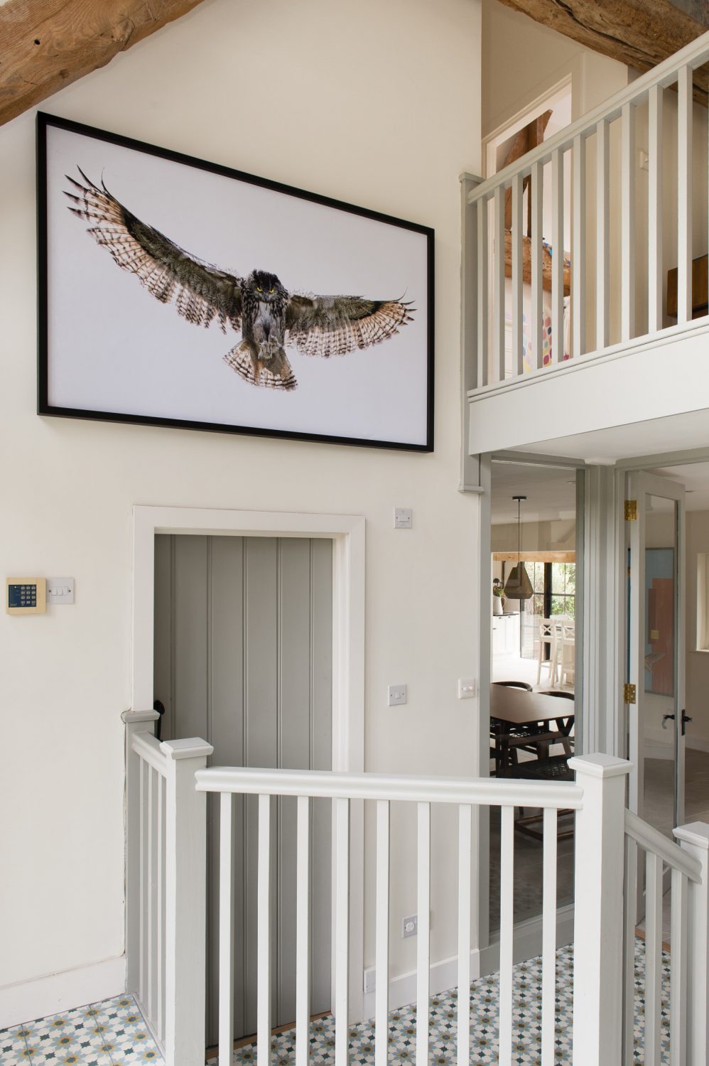 A large spread-winged owl, digital artwork created by Richard, looms over the galleried entrance hall