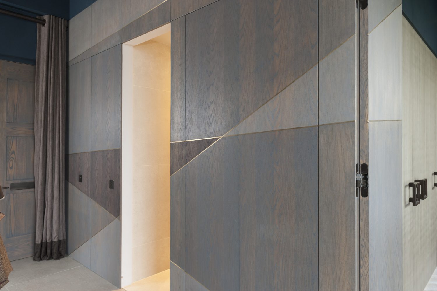 The attention to detail throughout the apartment is sublime – in a wall of beautiful geometric wood panelling, it is almost impossible to tell where the doors to the bedrooms and storage area are