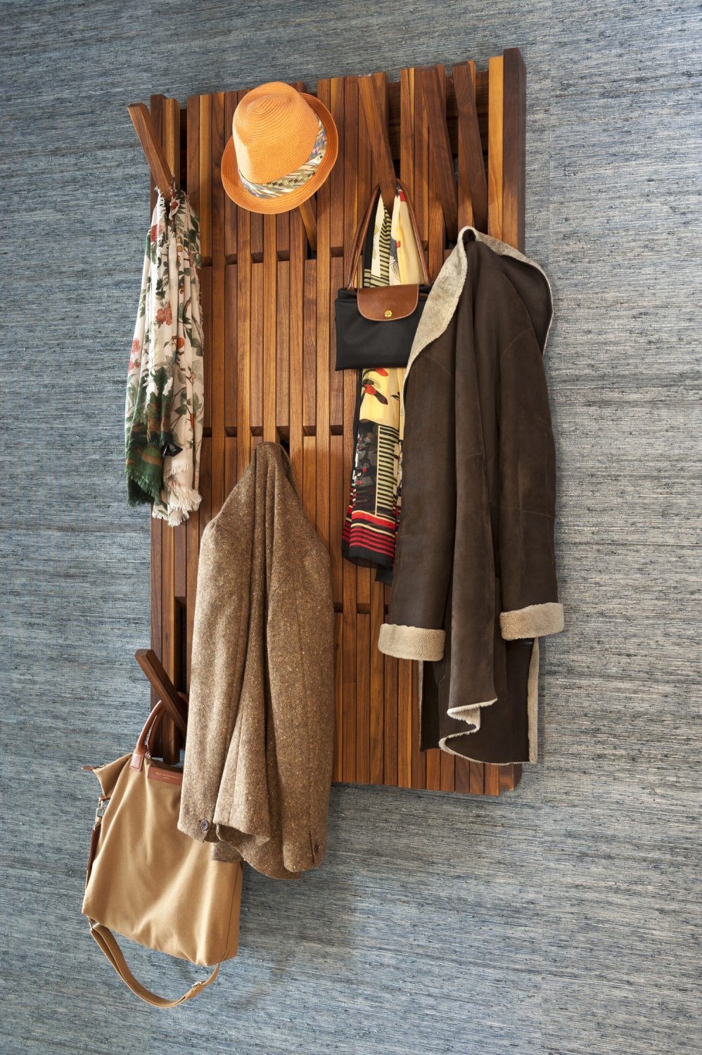 The spacious entrance way, with its artful piano coat rack is wonderfully uncluttered