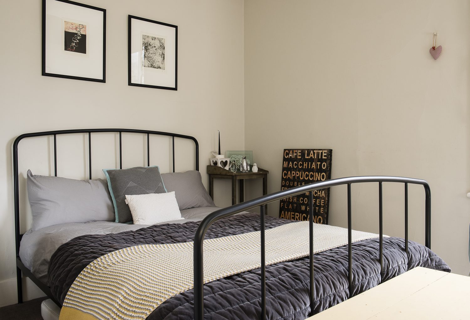 The guest bedroom features a metal bed frame from Made.com