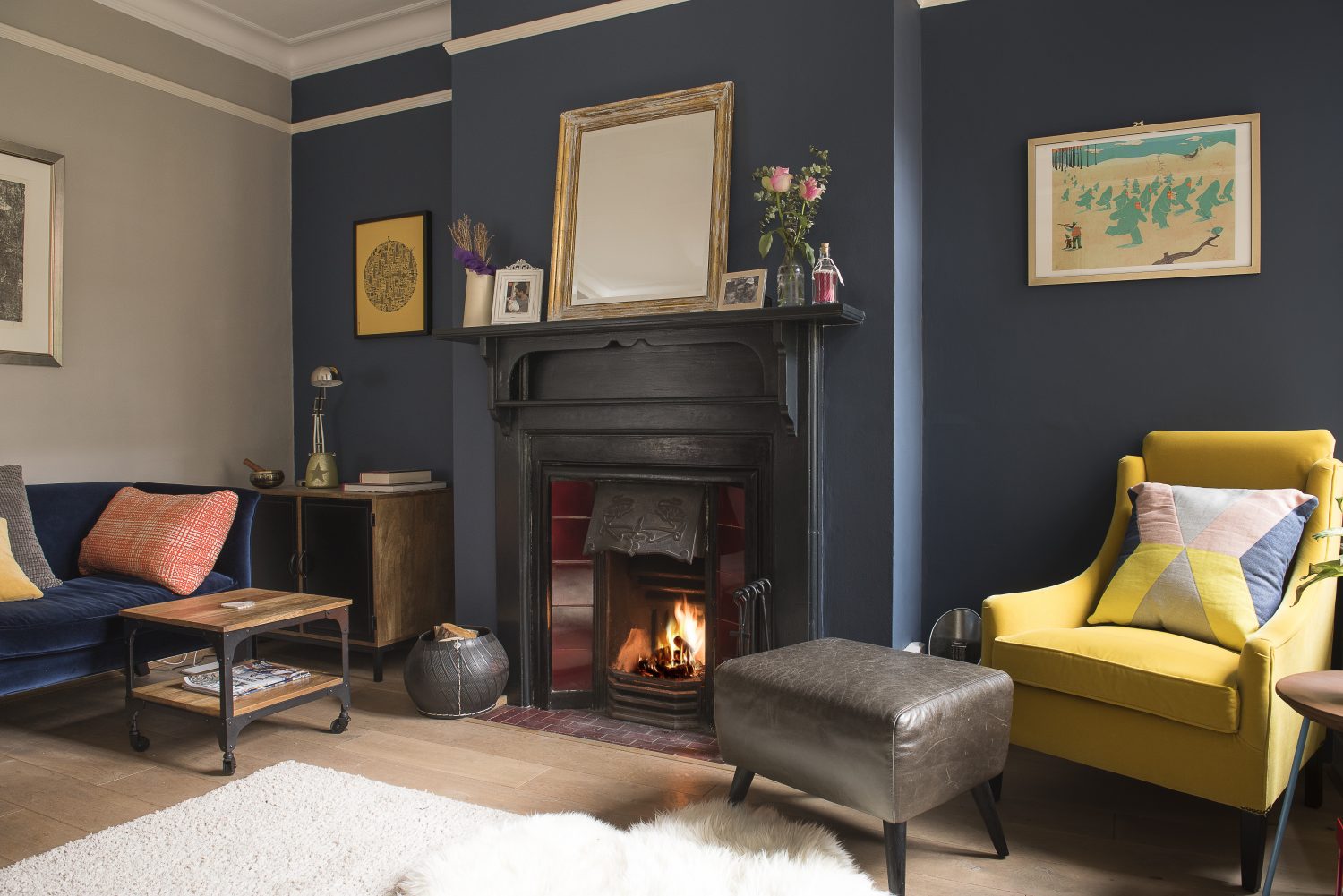 Next to the kitchen is a cosy room known as ‘the snug’. Initially a very light grey, and devoid of much natural light, Caroline has worked with the darkness, choosing deep tones and adding little pops of colour