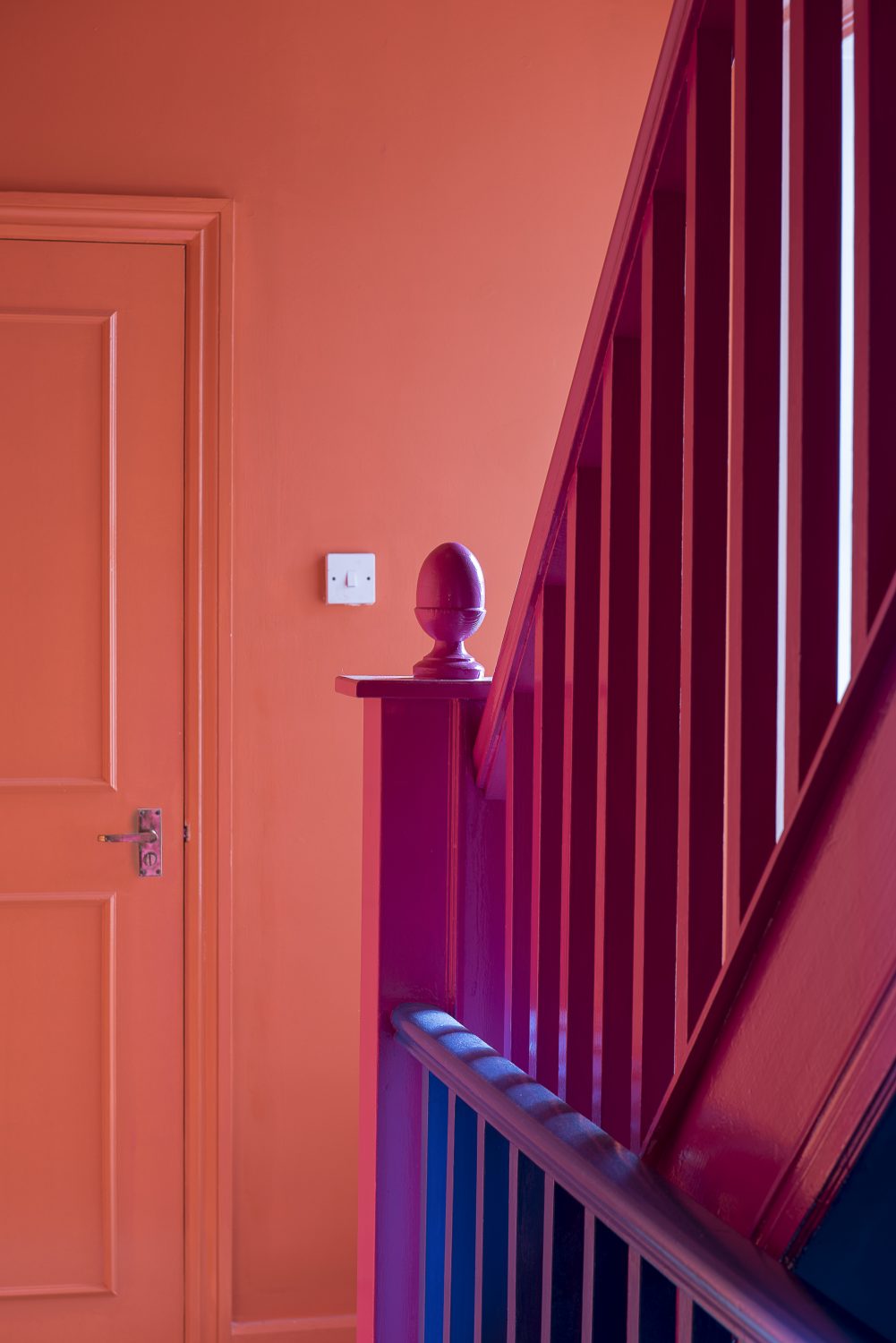 The staircase is a riot of pink and orange and is home to an Elvis bust spray painted by Amy the day before our visit