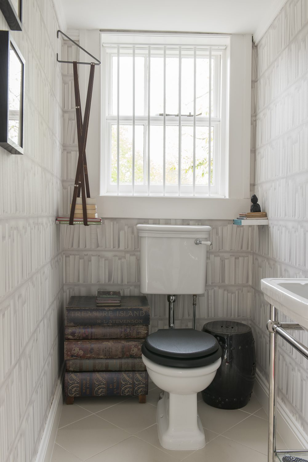 The ‘Library Loo’ featuring a table made of books, book cover art by the Connor Brothers, from Lilford Galleries in Canterbury, hanging books, book wallpaper – and a book that is really a shelf