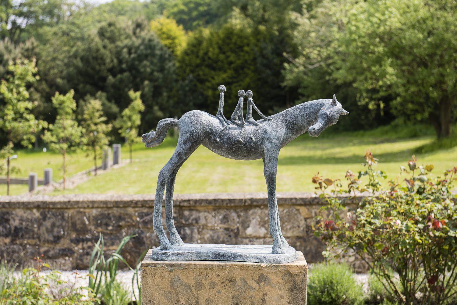 Sculptures by Carol Peace and Dawn Benson add interest on the terrace and among the borders