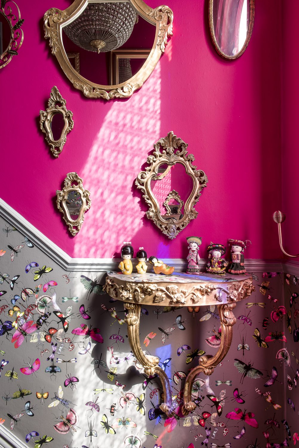 With its wall of mirrors, the hallway is Annemarie’s ‘homage to Versailles’. The butterfly wallpaper in the hall and up the stairs is by Christian Lacroix