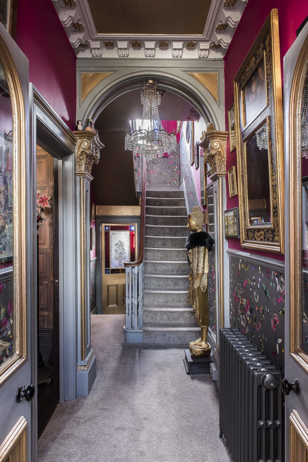 With its wall of mirrors, the hallway is Annemarie’s ‘homage to Versailles’. The butterfly wallpaper in the hall and up the stairs is by Christian Lacroix